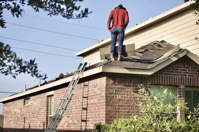 Professional roofer working on a residential roof in Robeson Crossing